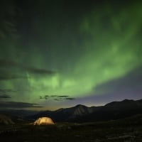 A tent under the Northern Lights on Summit Peak Trail