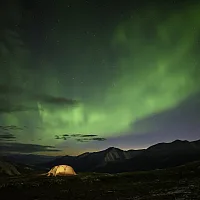 A tent under the Northern Lights on Summit Peak Trail