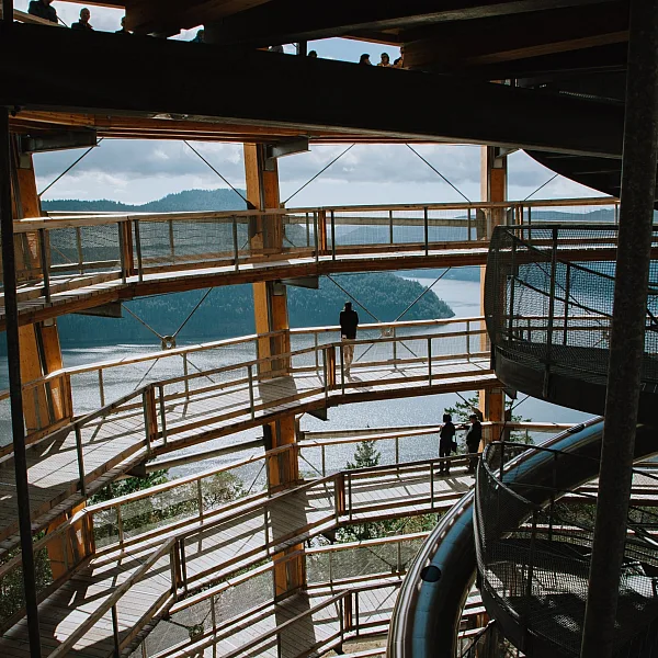 A view from the inside of a massive spiraling ramp that leads to a viewpoint over the ocean and the islands off Vancouver Island