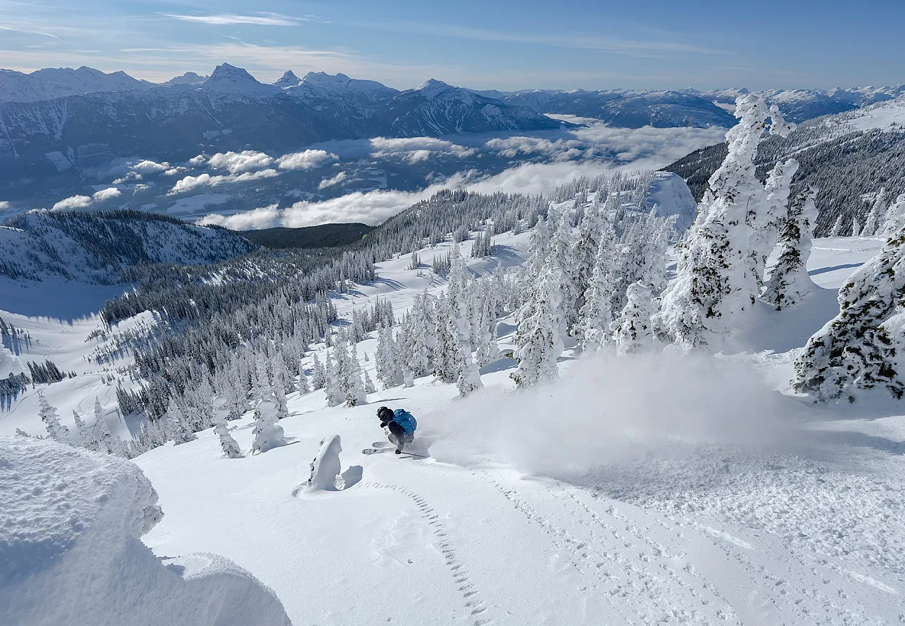 A person skiing down a snowy mountain