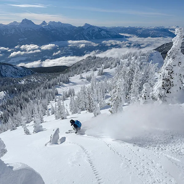 A person skiing down a snowy mountain