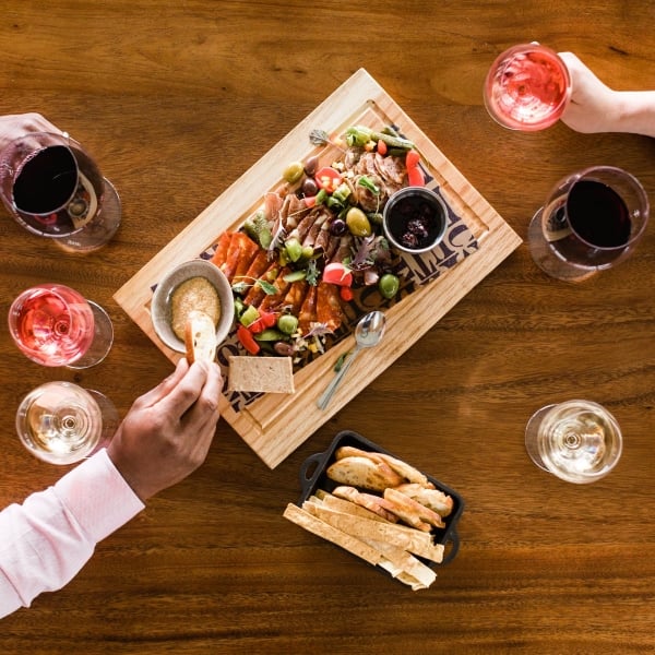 Top down view of a table with drinks and a shared charcuterie board for two diners at Mt. Boucherie Estate Winery in Kelowna