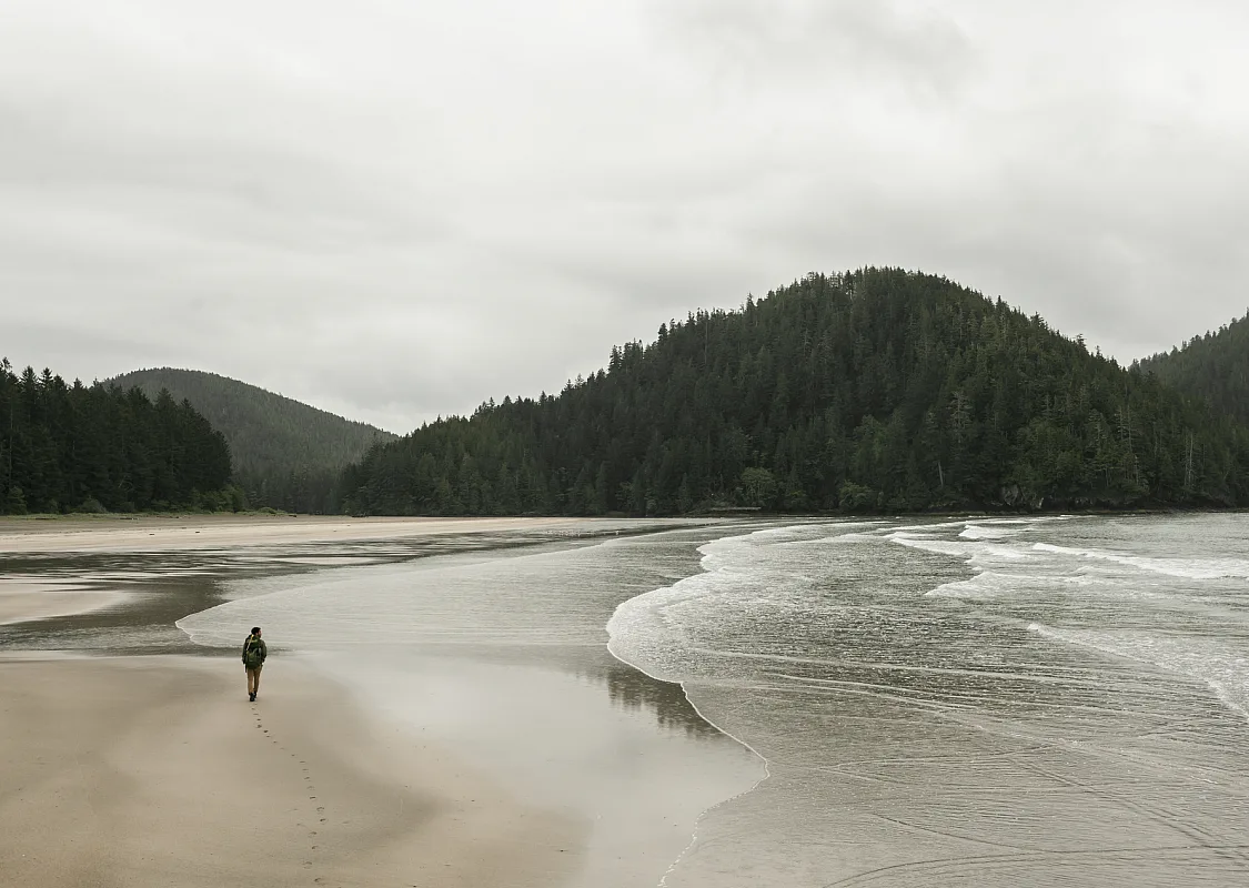 A person walks along the beach in San Josef Bay in Cape Scott Provincial Park