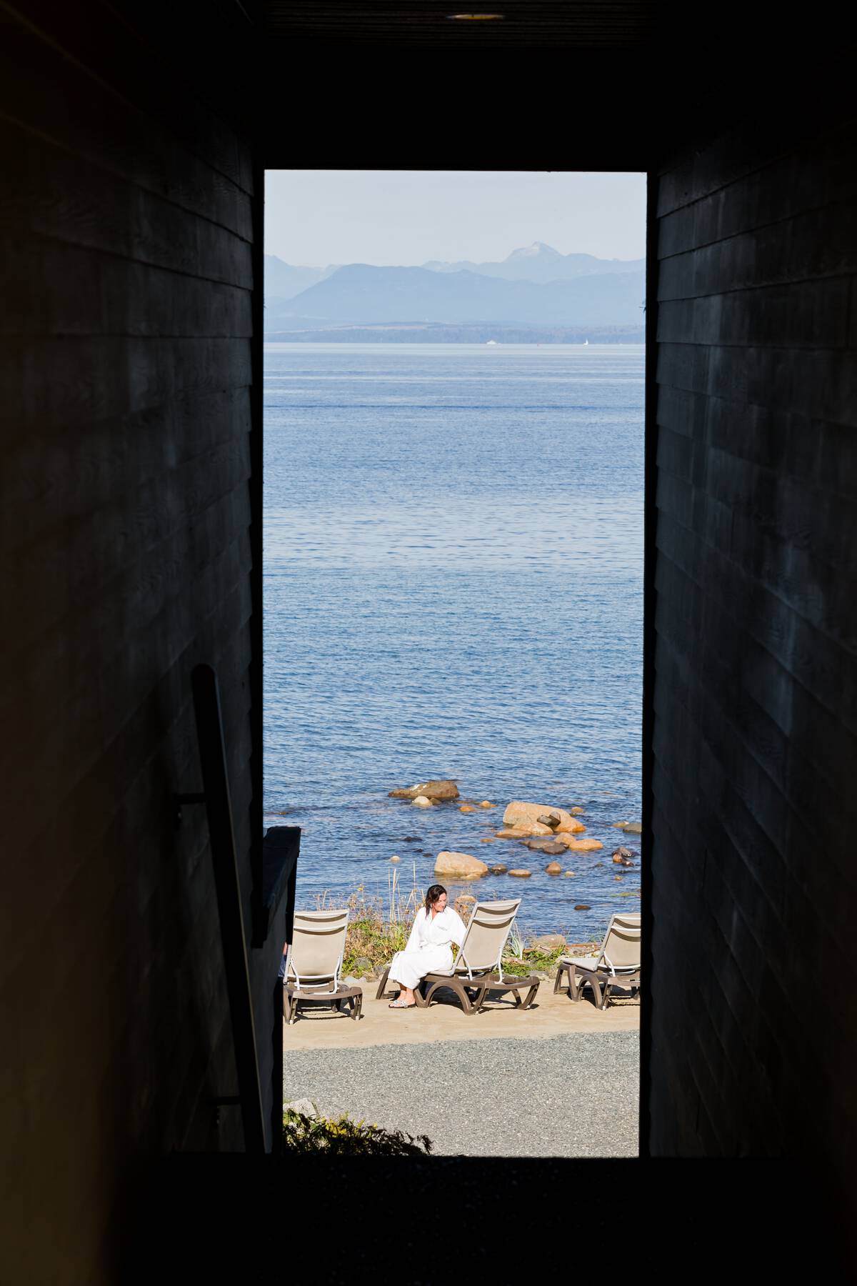 A person relaxes on an outdoor lounge chair at the Kingfisher Resort & Spa