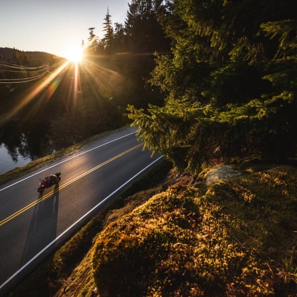 A motorcycle out for a sunset ride past Ruby Lake. There are no other vehicles on the road.