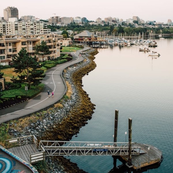Pedestrians on the False Creek seawall loop, from Cambie Street Bridge in Vancouver