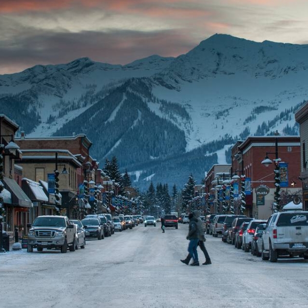 Downtown Fernie at dusk with a mountain landscape.