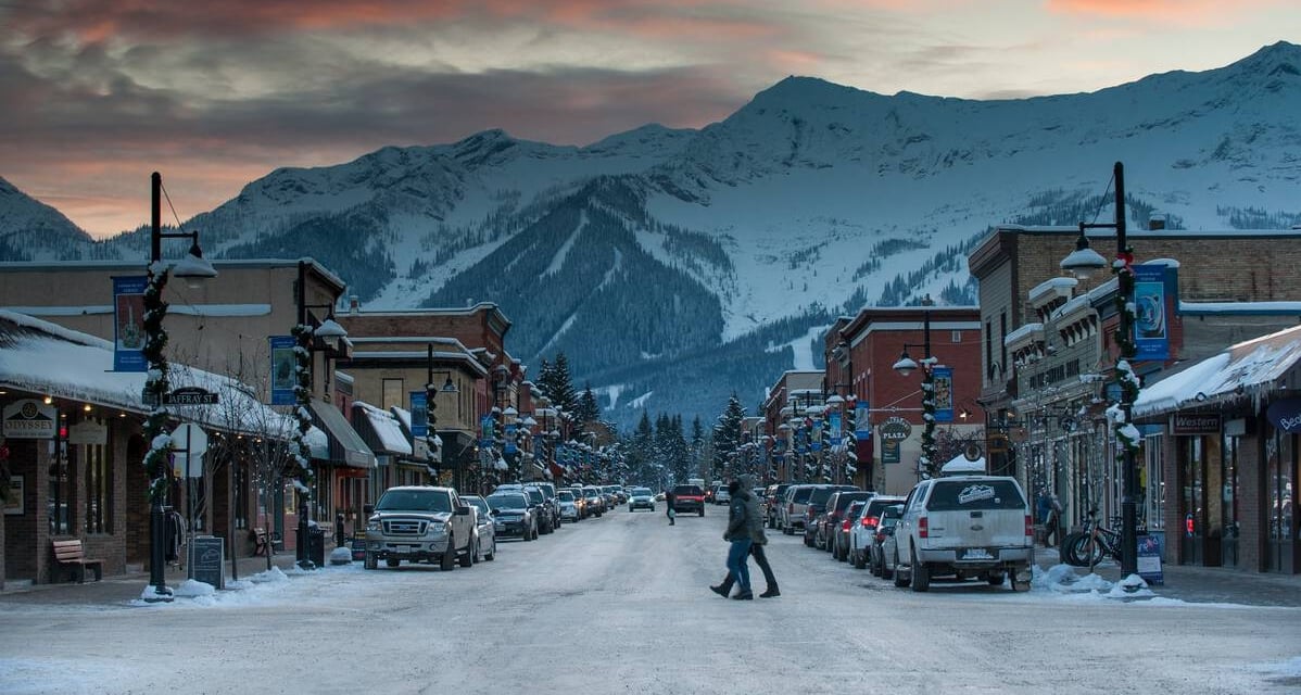 Downtown Fernie at dusk with a mountain landscape.