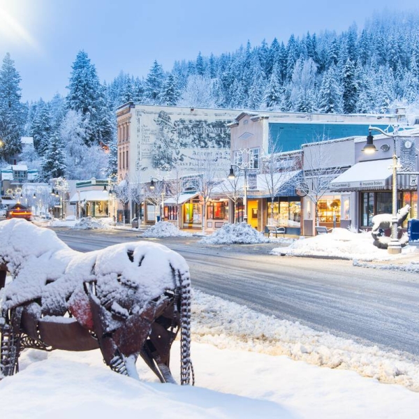 Downtown Rossland with snow-covered historic buidings and an iron horse statue.