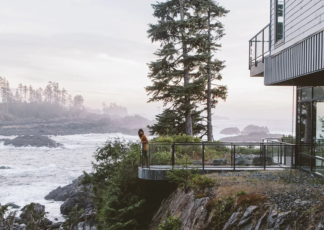 A person stands on the deck of the Black Rock Oceanfront Resort in Ucluelet