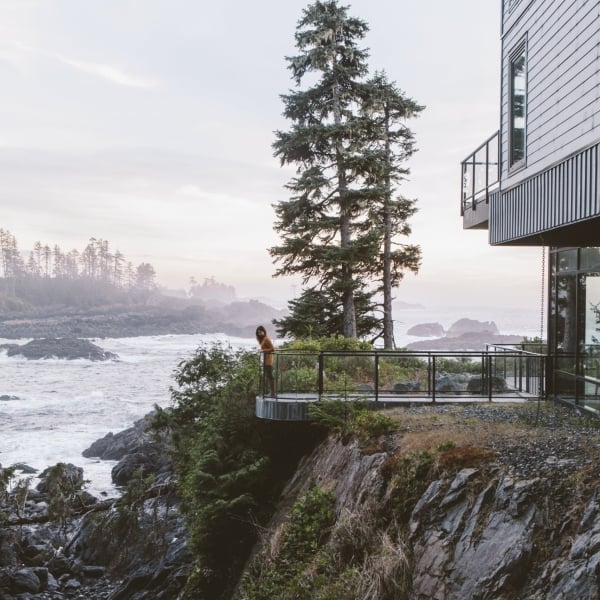 A person stands on the deck of the Black Rock Oceanfront Resort in Ucluelet