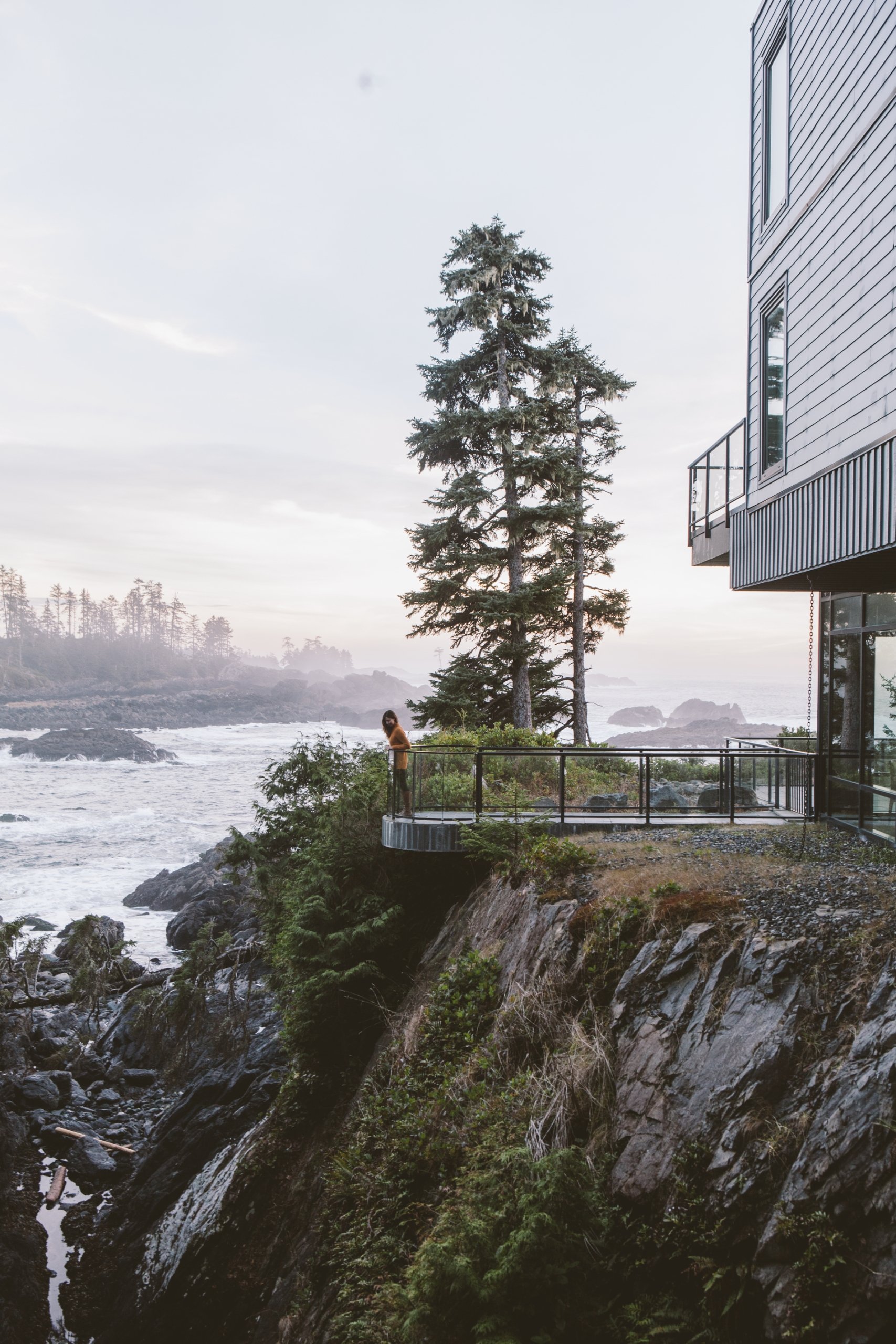 A person stands on the deck of the Black Rock Oceanfront Resort in Ucluelet