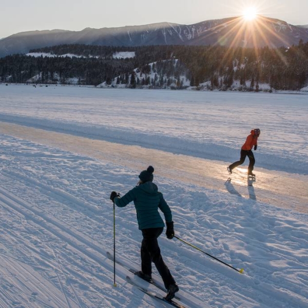 Cross-country skier and skater on the Whiteway on Windermere Lake, near Invermere BC