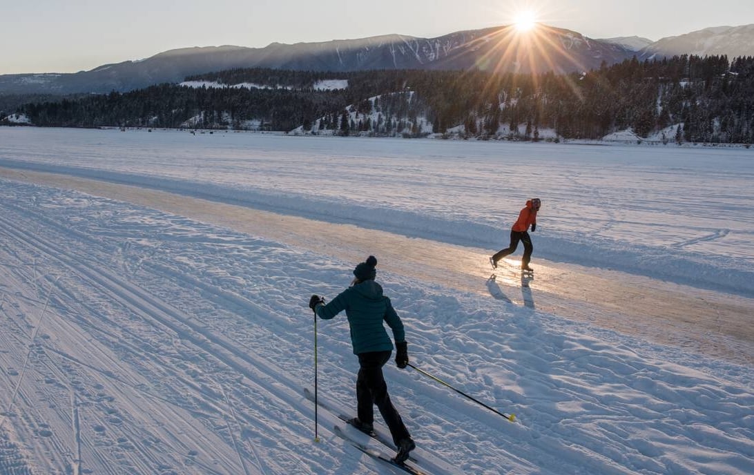 Cross-country skier and skater on the Whiteway on Windermere Lake, near Invermere BC