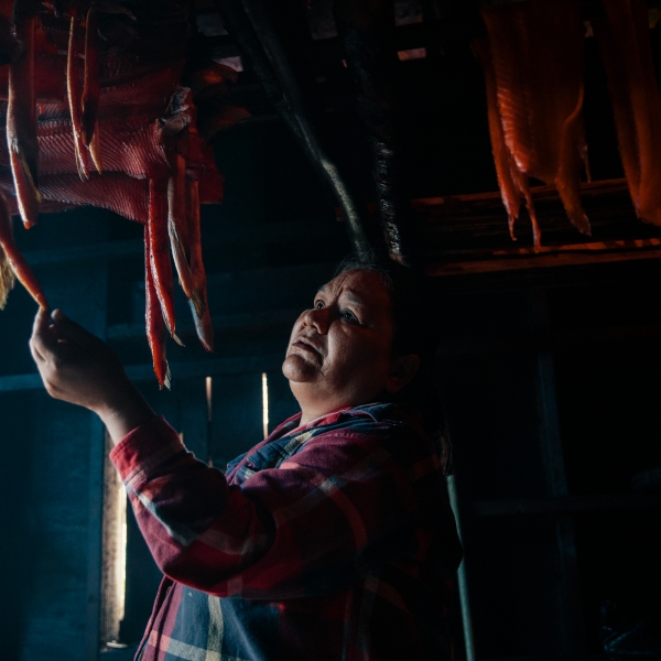A person sorts through smoking salmon in a smoke house in village of Gingolx in the Nisga'a Nation.