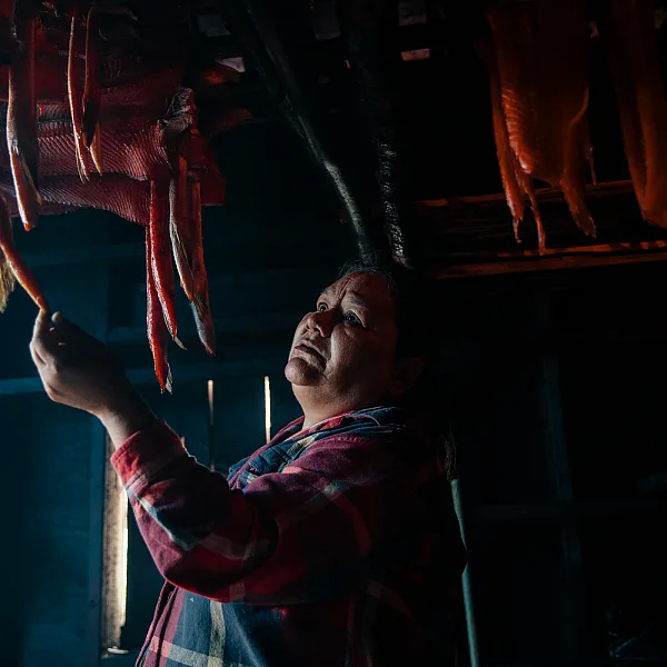 A person sorts through smoking salmon in a smoke house in village of Gingolx in the Nisga'a Nation.