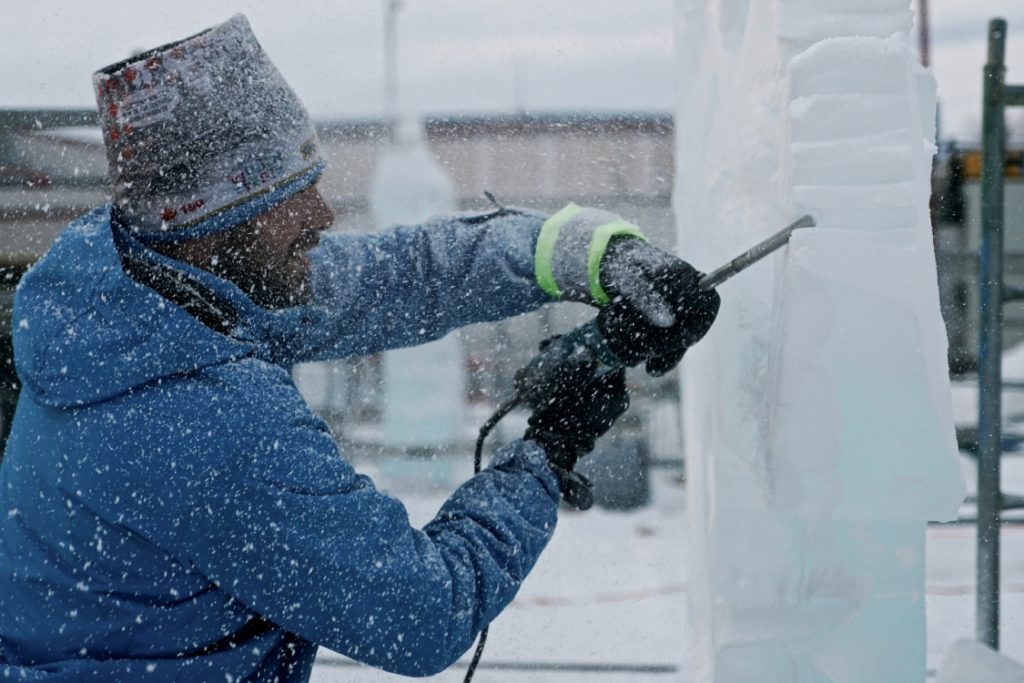 A person creating an ice sculpture