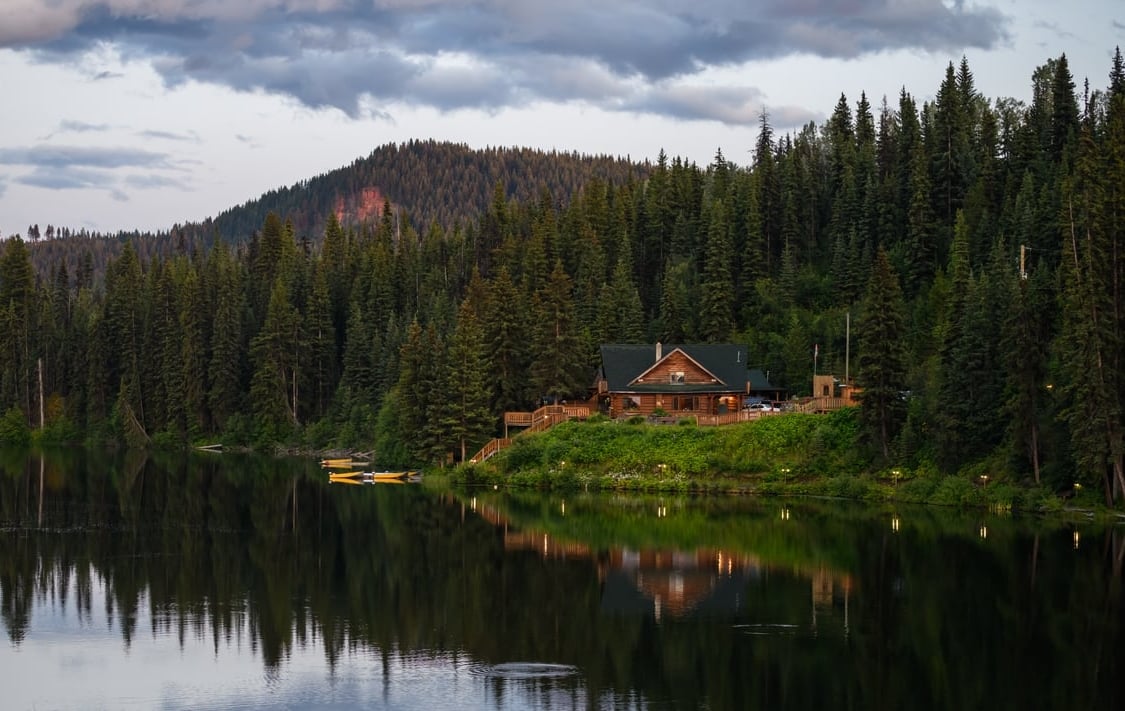 The lakeshore cabins and restaurant at the Lac des Roches Resort seen from across the lake.