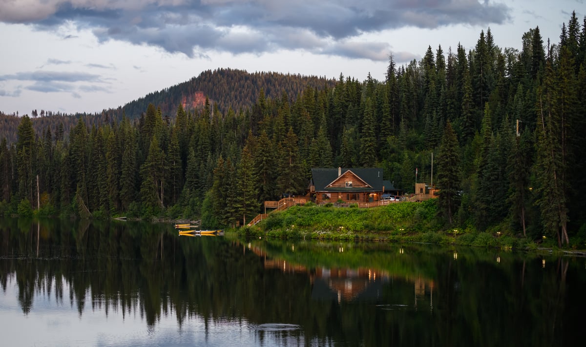 The lakeshore cabins and restaurant at the Lac des Roches Resort seen from across the lake.