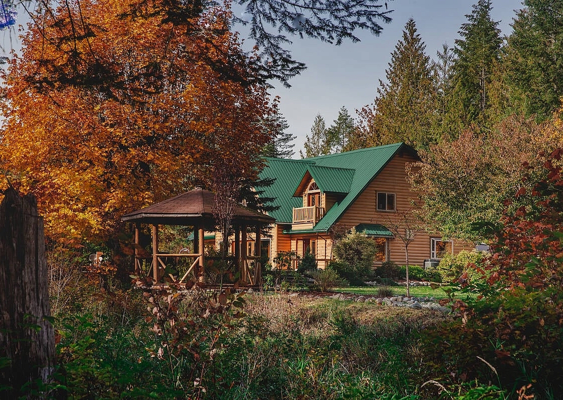 Cowichan River Lodge entre árboles con hojas de otoño en Lake Cowichan