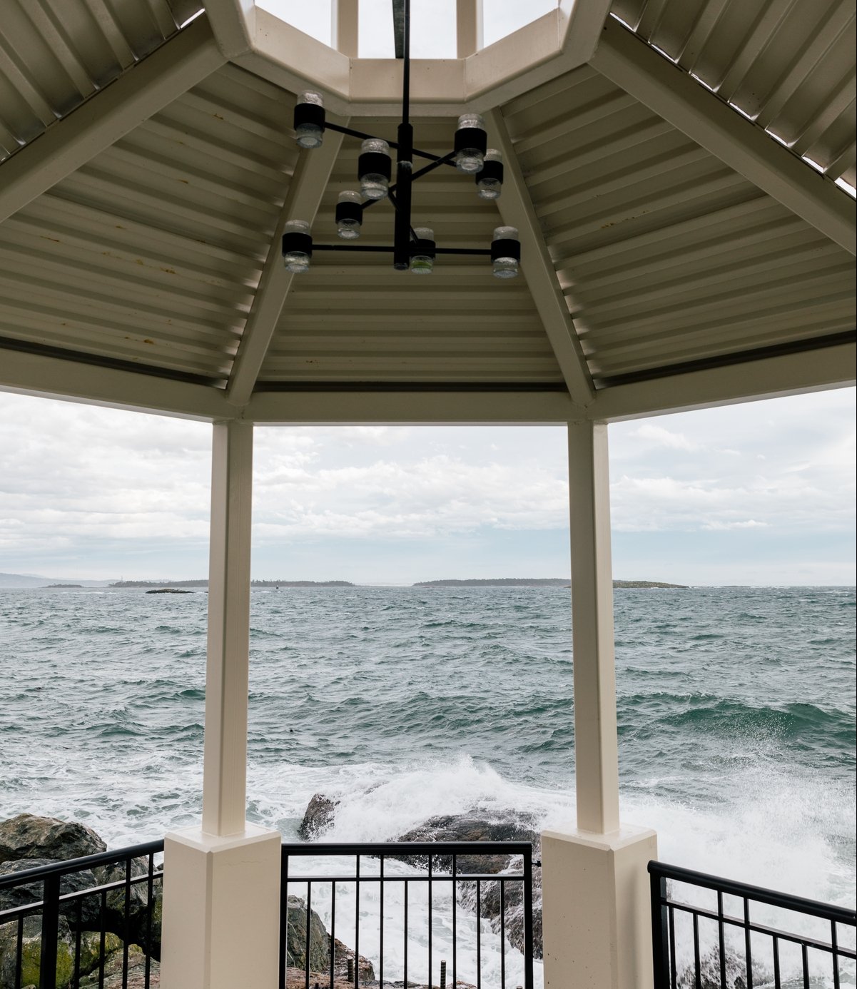 An ocean front viewing deck from the Oak Bay Beach hotel. The waves crash in front.
