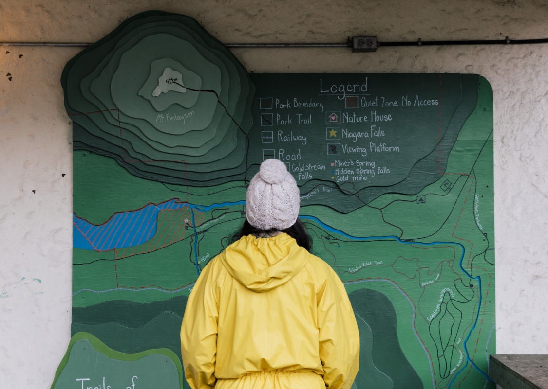 Person viewing the trail map at Goldstream Provincial Park