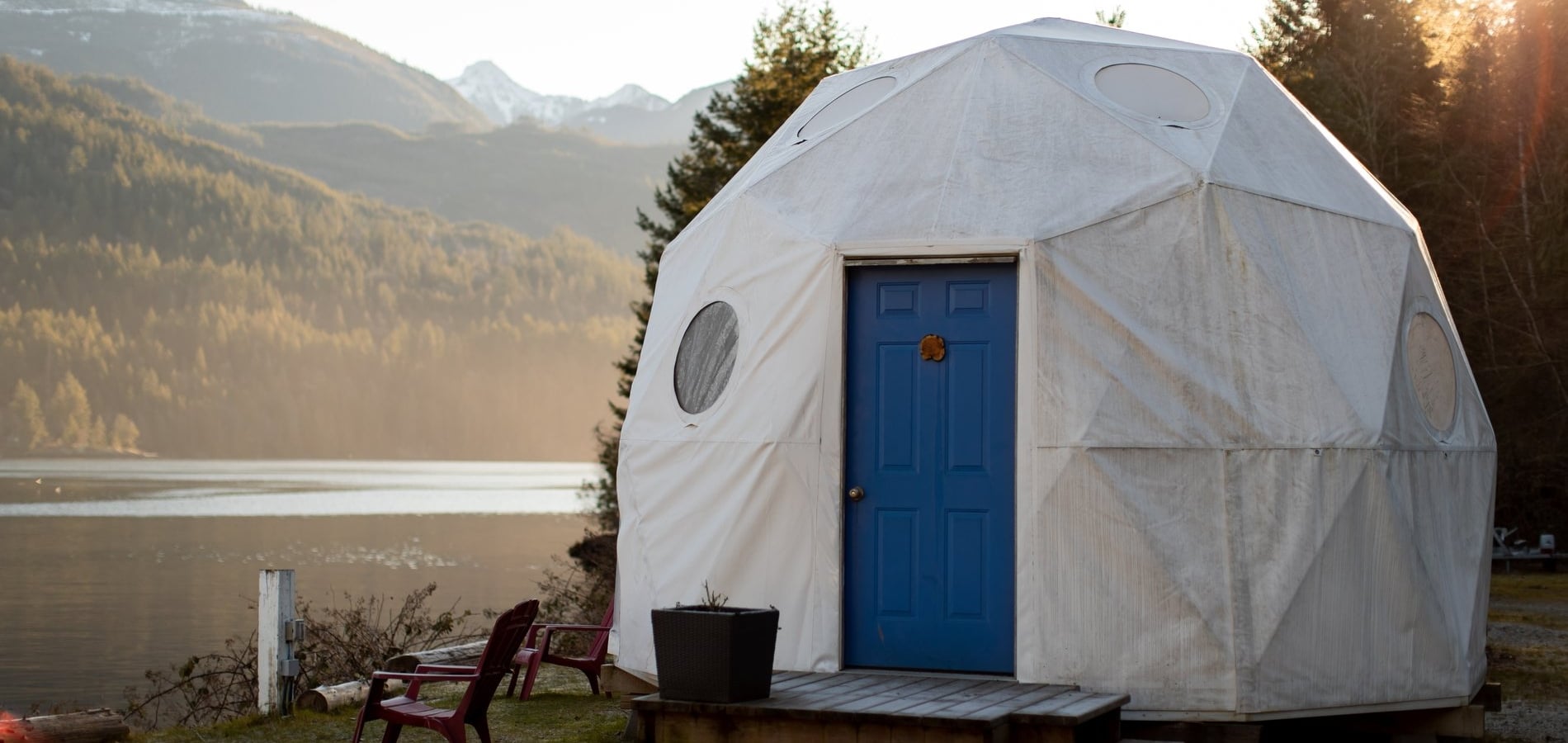 A white dome structure with a blue door on the beach in Tofino from Backeddy Resort.