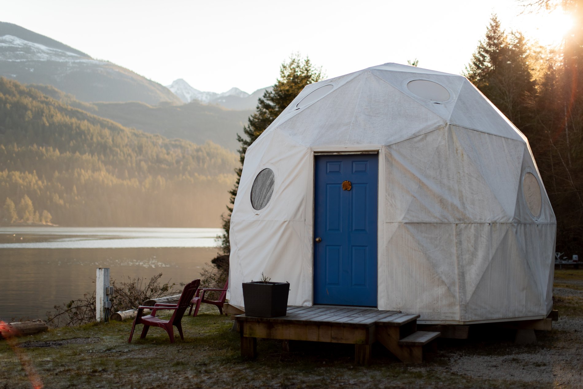 A white dome structure with a blue door on the beach in Tofino from Backeddy Resort.