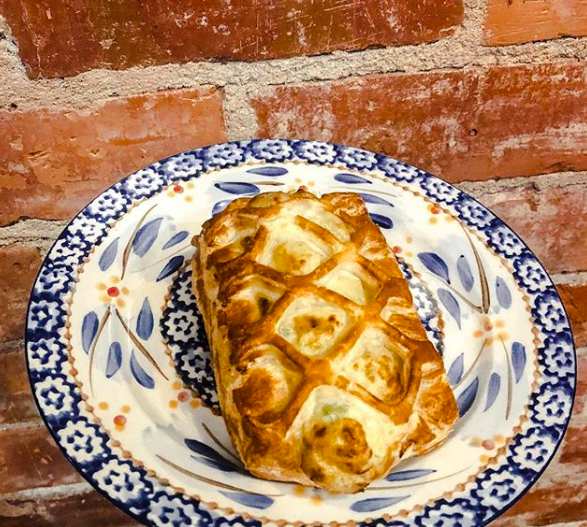 A pastry on a blue and white dish from the Wooden Spoon.
