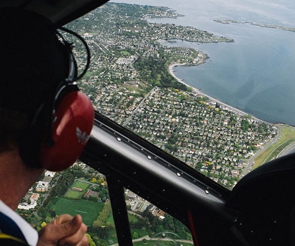 Aerial shot from inside a plane looking down at Victoria below