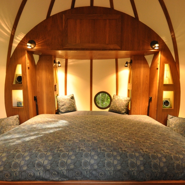 Inside of the Free Spirit Spheres. The murphy bed is pulled down from the cabinet in the wall.
