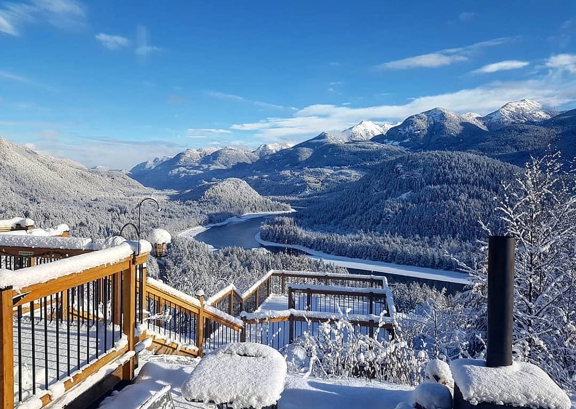 A snowy view of the Fraser River and mountains from American Creek Lodge