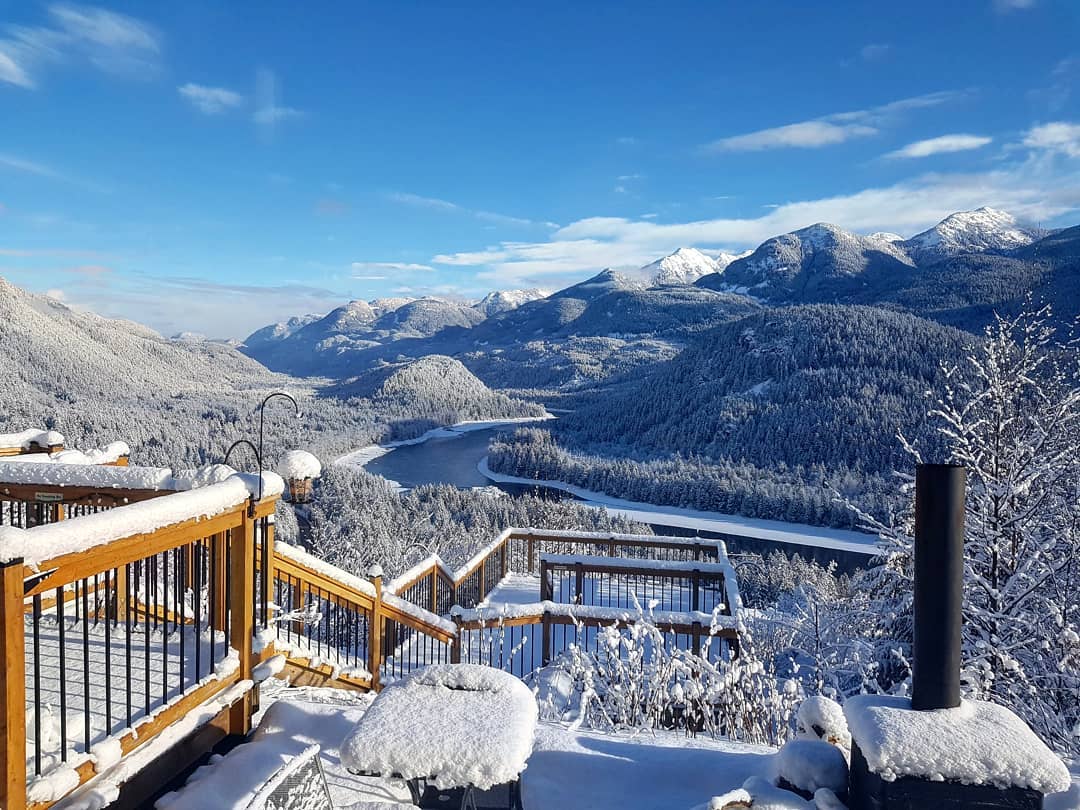 A snowy view of the Fraser River and mountains from American Creek Lodge