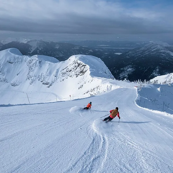 A duo of skiers downhill skiing at Fernie Alpine Resort.