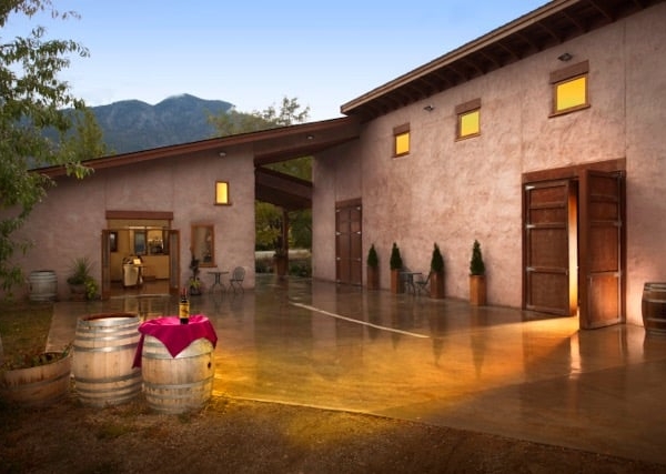 The front of the main building for Orofino Winery. A one-storey building with large wooden doors and small windows above them.