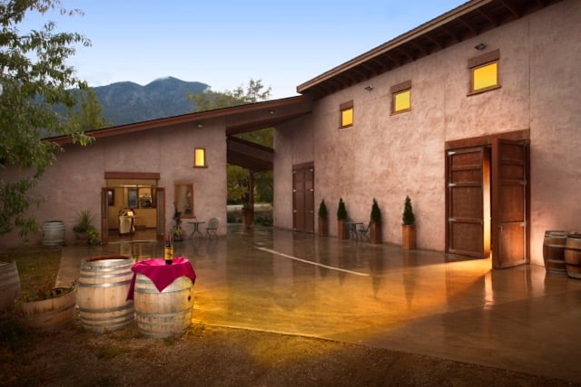 The front of the main building for Orofino Winery. A one-storey building with large wooden doors and small windows above them.