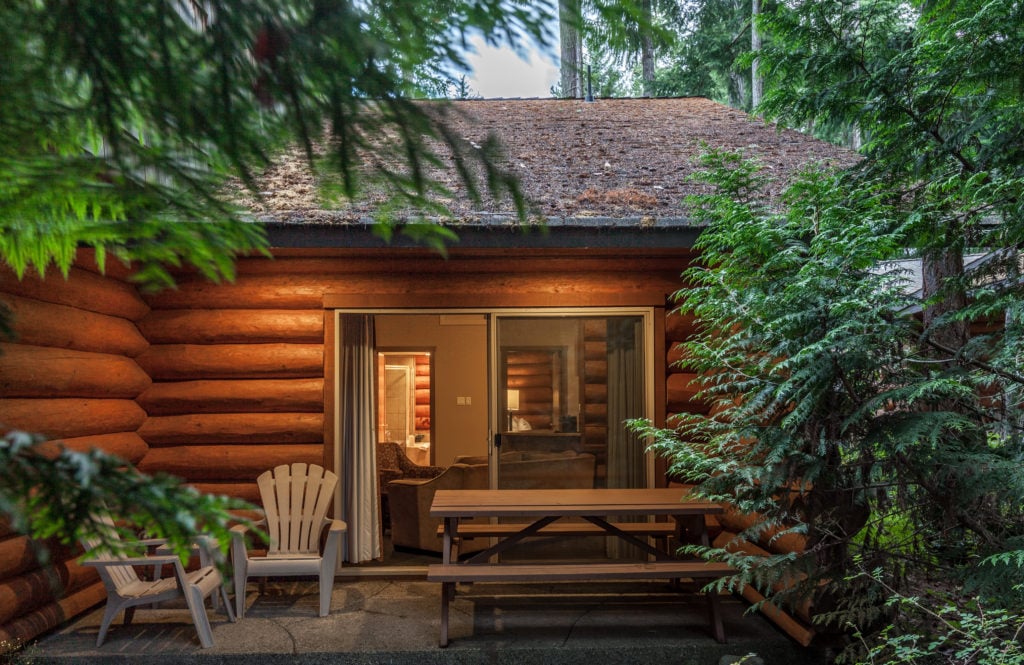The outside of a cosy log cabin in the forest
