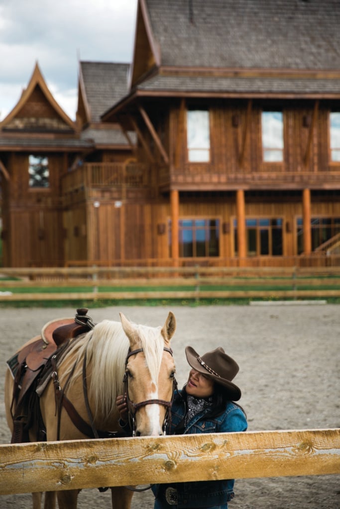 A women stands next to a horse outside of the Echo Valley Ranch & Spa.