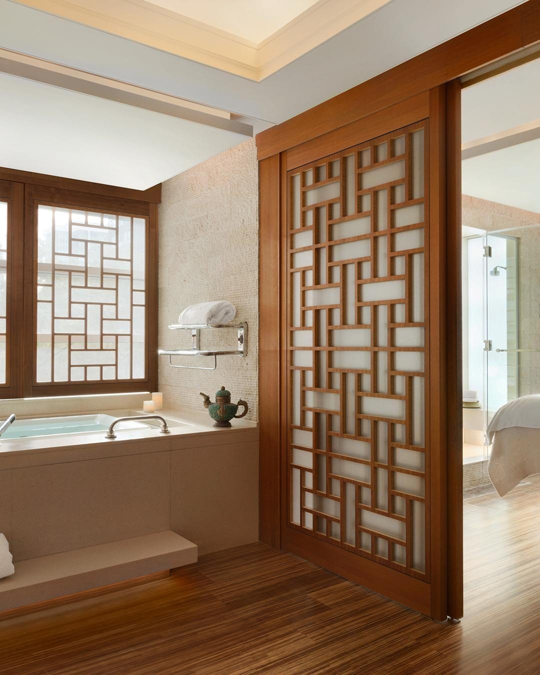 A spa bathroom with a slider door to a bedroom