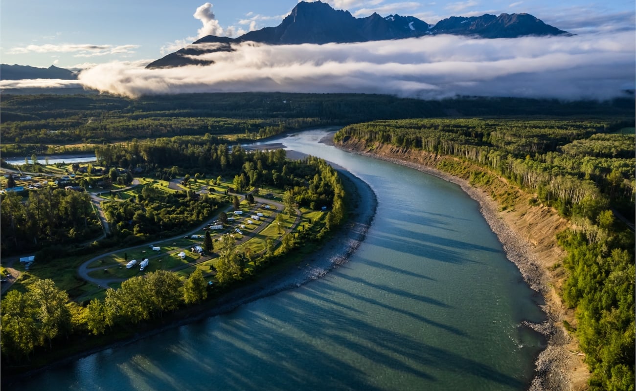 View of a river by cloudy mountains