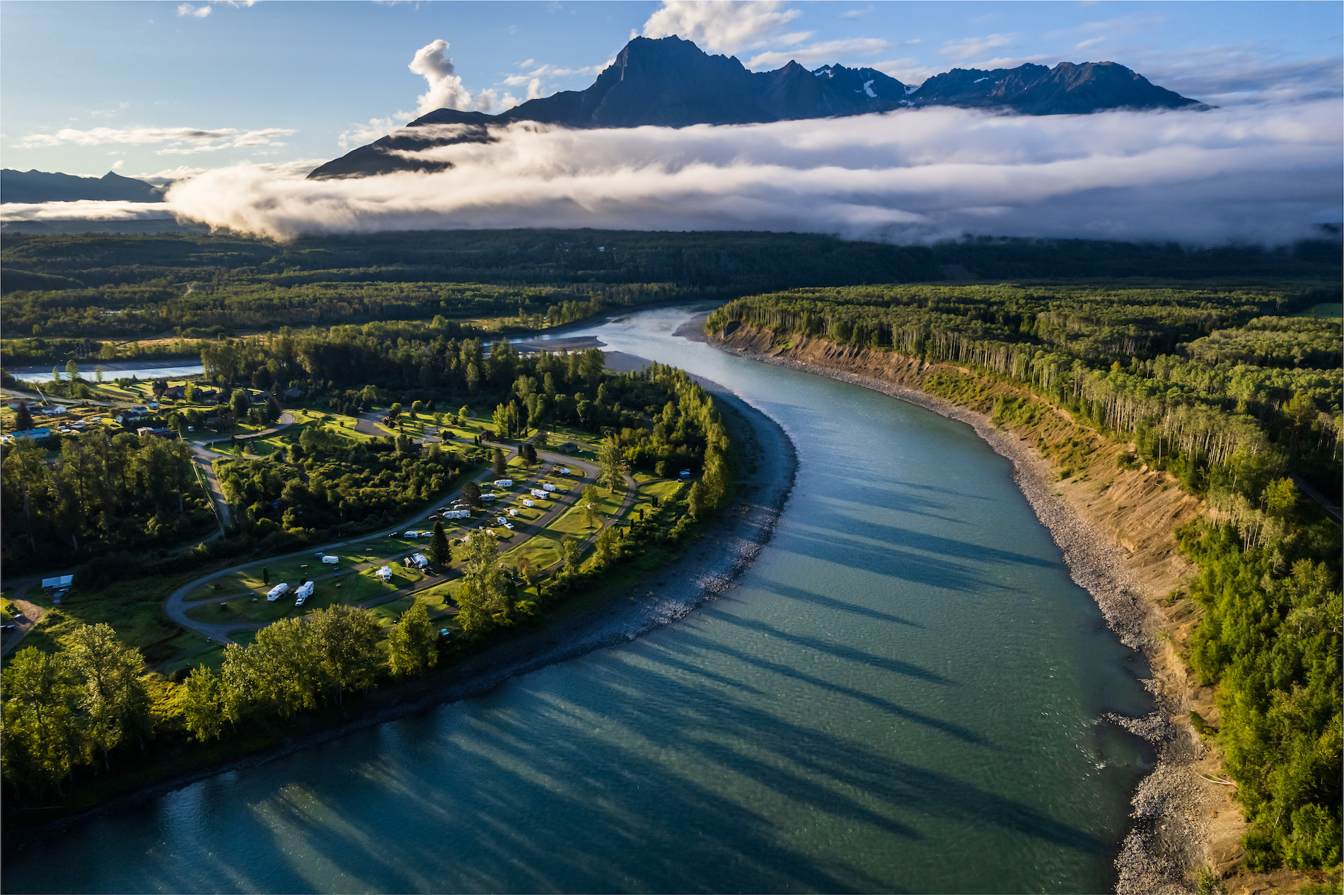 View of a river by cloudy mountains