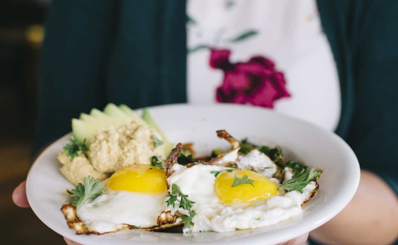 A woman carries a heaping plate of eggs at Whole Wheat & Honey restaurant in Fort St. John.
