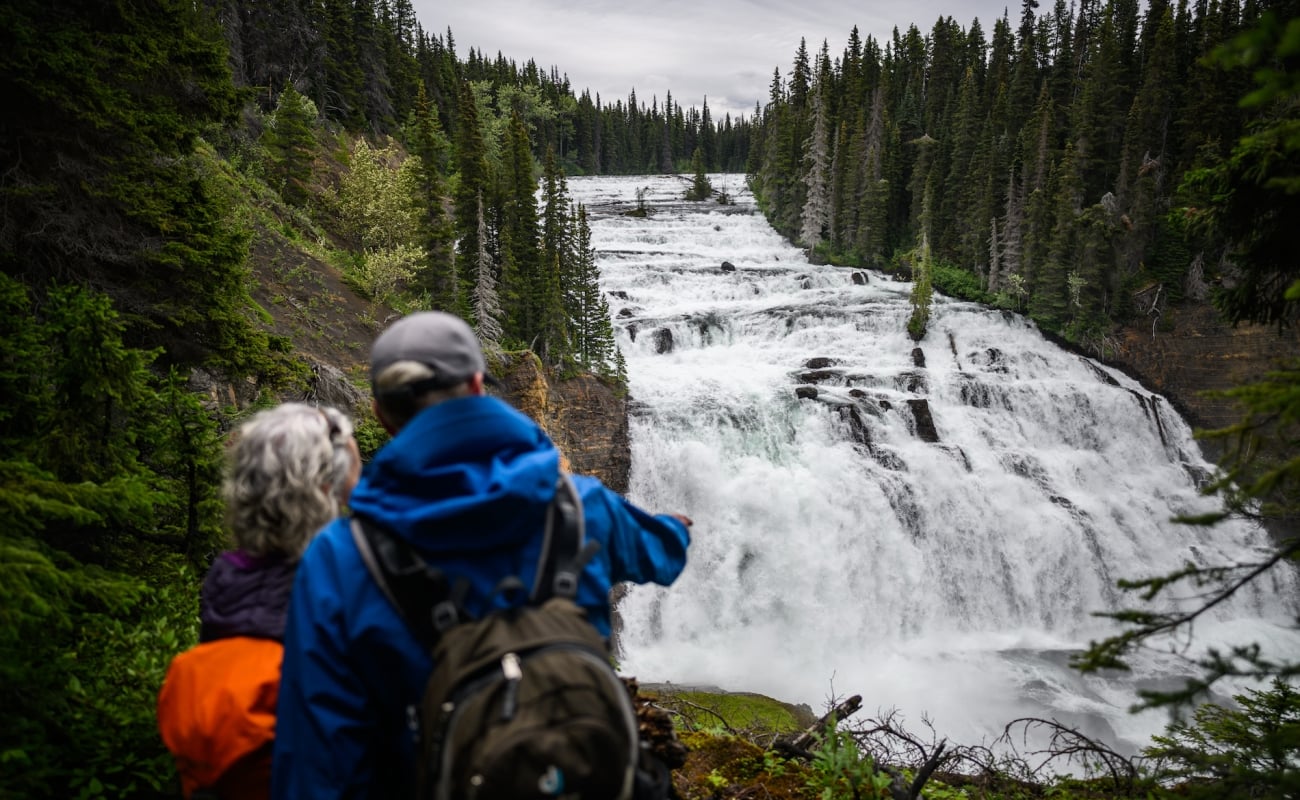 A couple overlooks the Cascade Falls in Kinaskan Lake Provincial Park near Iskut.