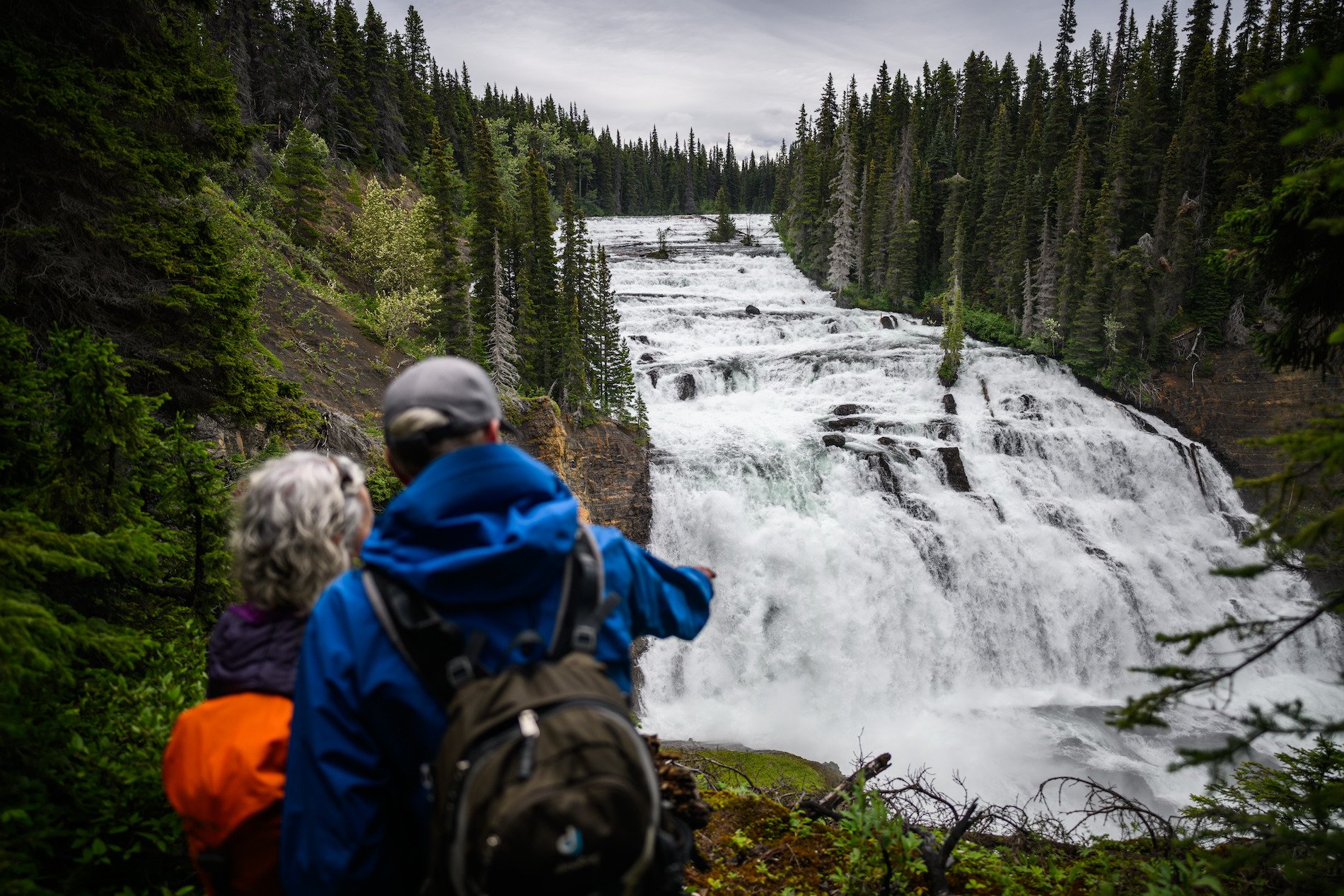 A couple overlooks the Cascade Falls in Kinaskan Lake Provincial Park near Iskut.