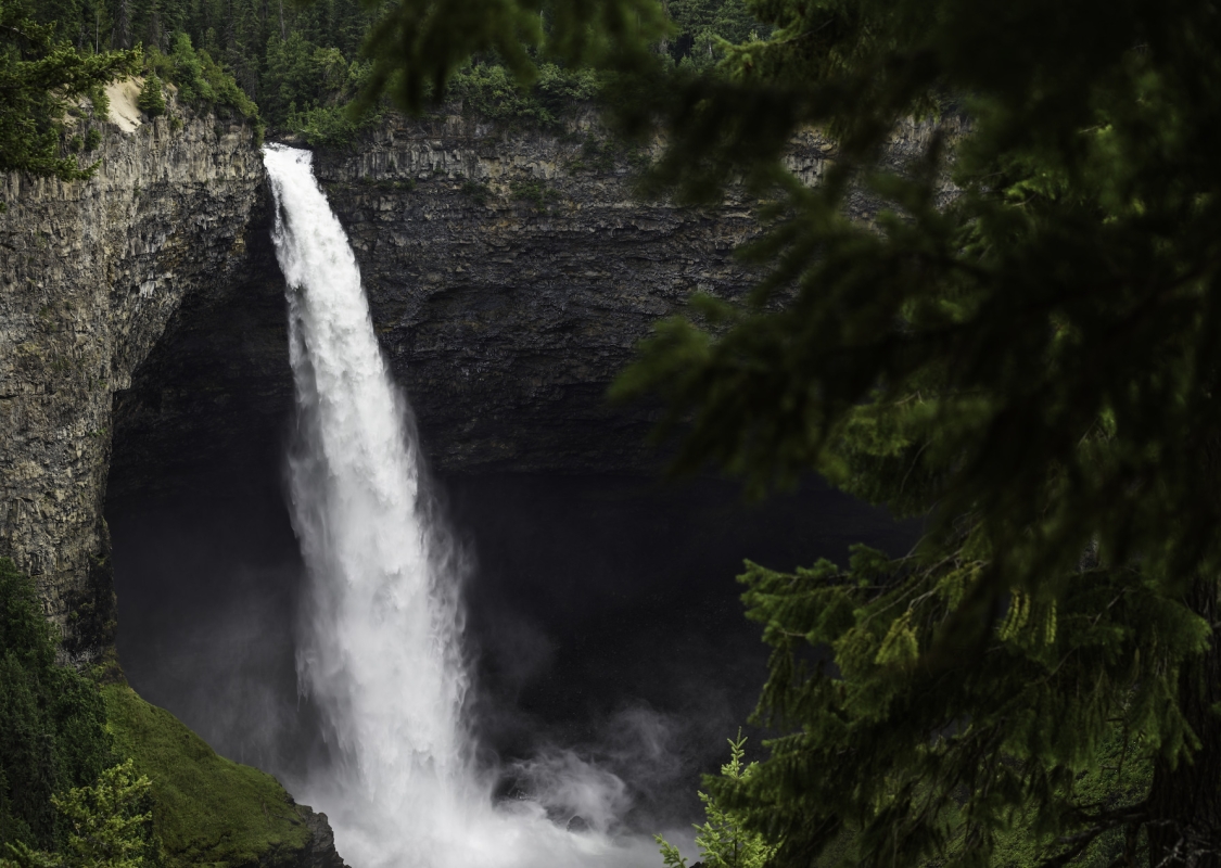 Helmcken Falls at Wells Gray Provincial Park. The waterfall plunges down from a high ledge into the pool below.