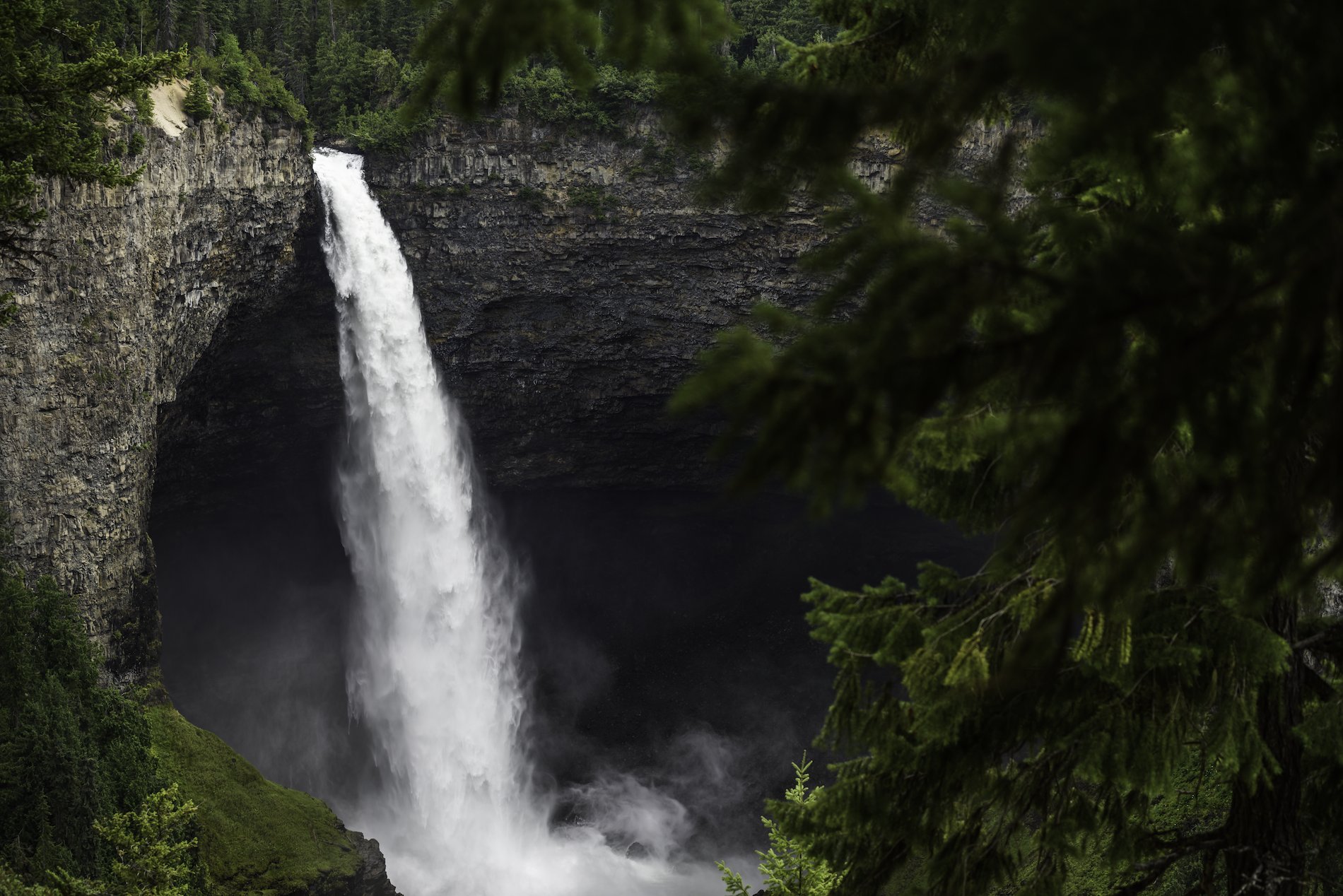 Helmcken Falls at Wells Gray Provincial Park. The waterfall plunges down from a high ledge into the pool below.