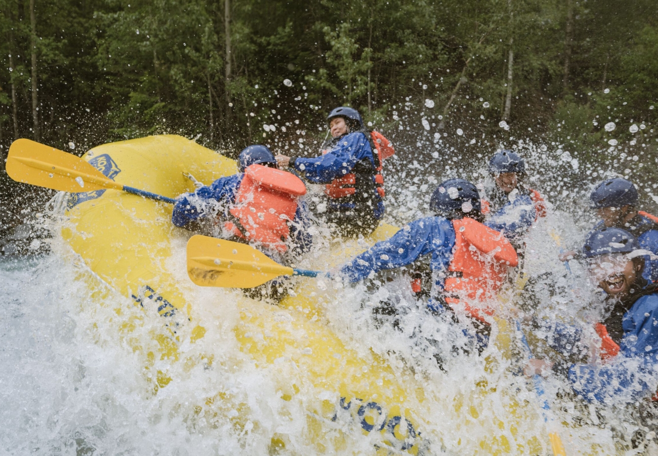 A river raft gets air and lots of splashing.