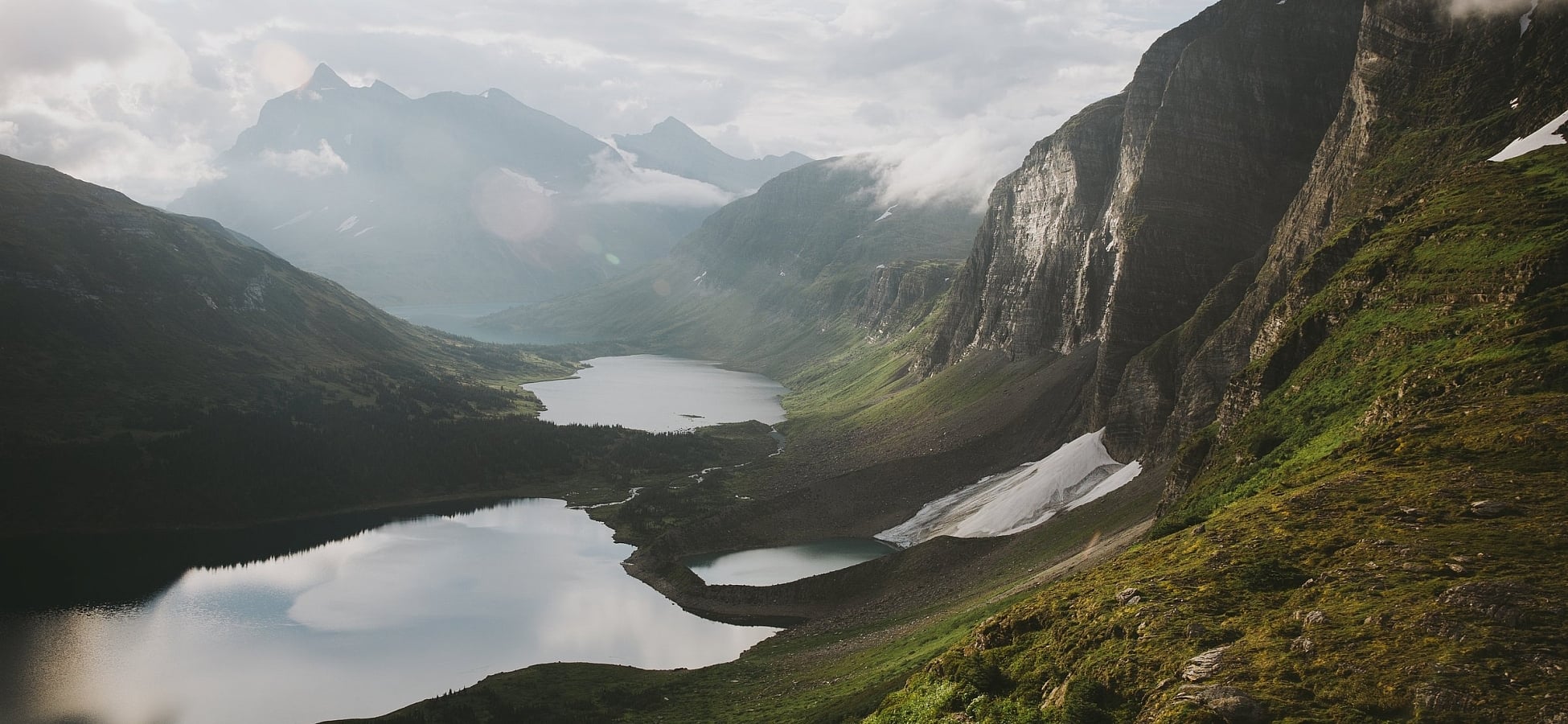Towering mountains and moss-covered plateaus overlook several alpine lakes.