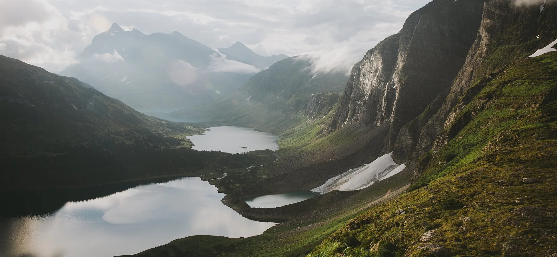 Towering mountains and moss-covered plateaus overlook several alpine lakes.