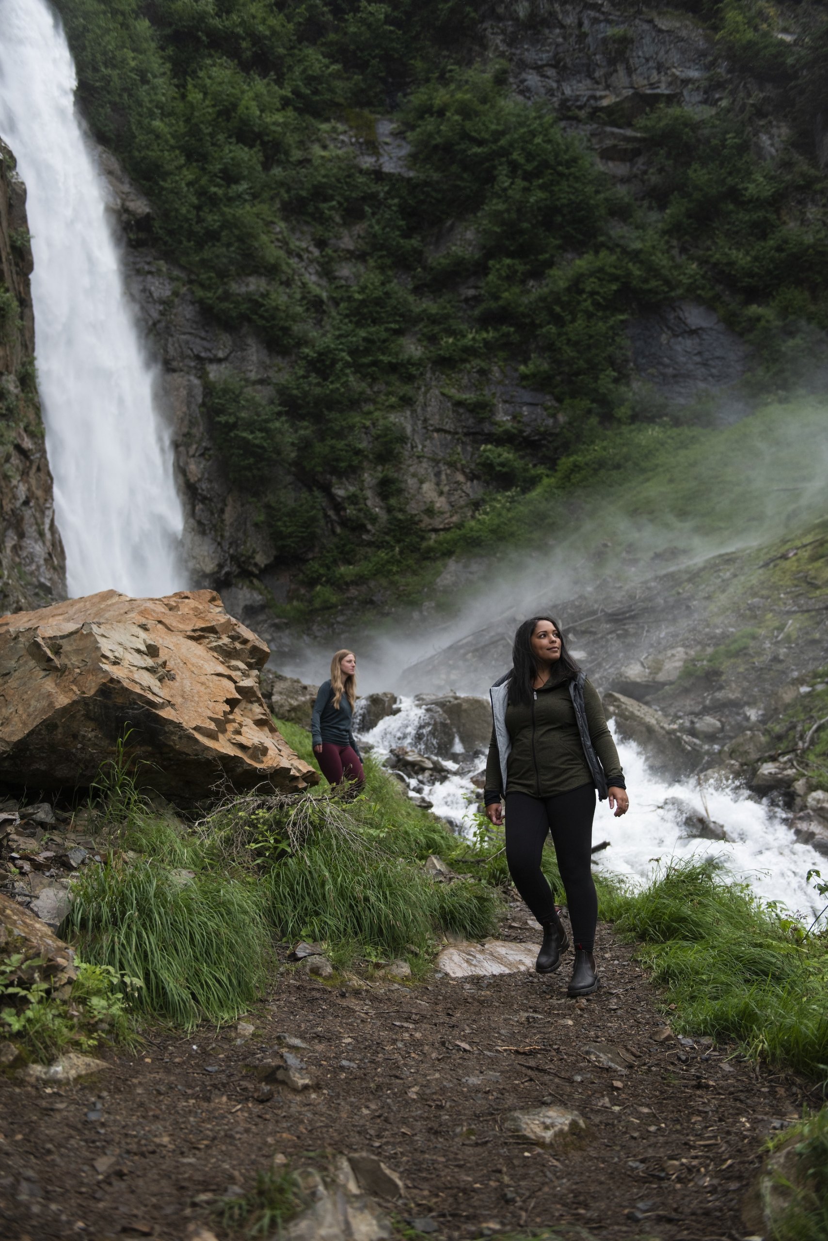 People hiking next to a river